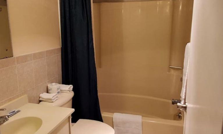 Guest bathroom with shower at Bay Breeze Motel.