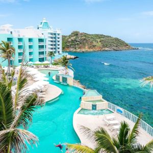 Stunning outdoor pool and ocean view at Oyster Bay Beach Resort.