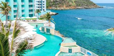 Stunning outdoor pool and ocean view at Oyster Bay Beach Resort.