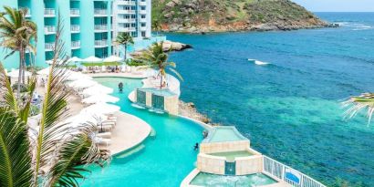 Stunning outdoor pool and ocean view at Oyster Bay Beach Resort.