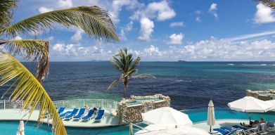 Relaxing outdoor pool and ocean view at Oyster Bay Beach Resort.