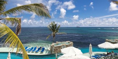 Relaxing outdoor pool and ocean view at Oyster Bay Beach Resort.