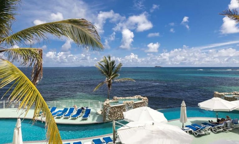 Relaxing outdoor pool and ocean view at Oyster Bay Beach Resort.