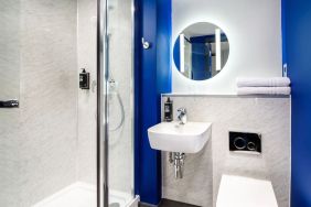 Private bathroom with shower at Ibis Budget Manchester Airport.