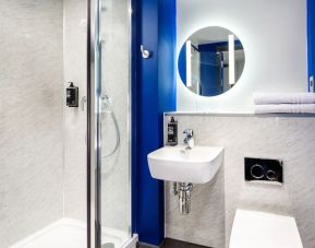 Private bathroom with shower at Ibis Budget Manchester Airport.