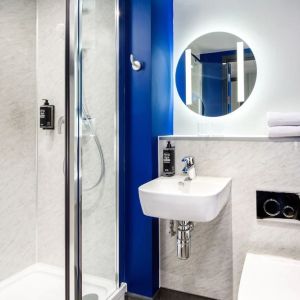 Private bathroom with shower at Ibis Budget Manchester Airport.