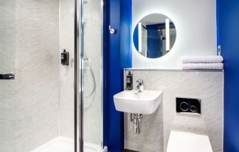 Private bathroom with shower at Ibis Budget Manchester Airport.