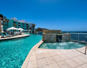 Glistening pool during daytime alongside jacuzzi hot tub at Oyster Bay Resort in St. Maarten.