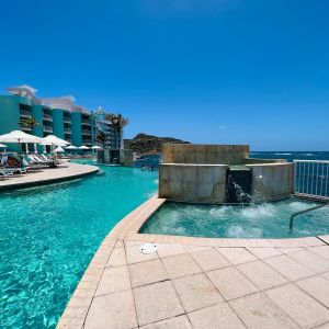 Glistening pool during daytime alongside jacuzzi hot tub at Oyster Bay Resort in St. Maarten.