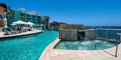 Glistening pool during daytime alongside jacuzzi hot tub at Oyster Bay Resort in St. Maarten.