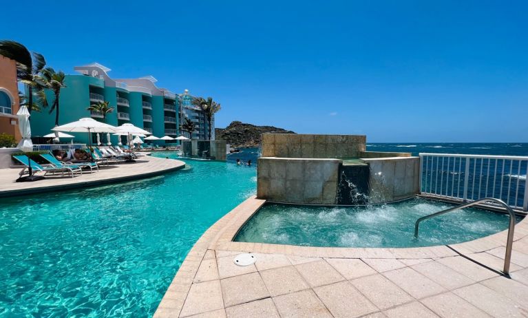 Glistening pool during daytime alongside jacuzzi hot tub at Oyster Bay Resort in St. Maarten.