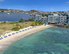 Oyster Bay Resort in St. Martin with buildings along beach and bay. 