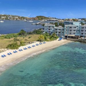 Oyster Bay Resort in St. Martin with buildings along beach and bay. 