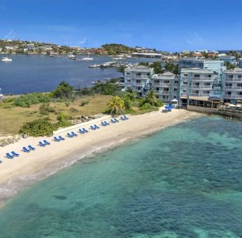 Oyster Bay Resort in St. Martin with buildings along beach and bay. 