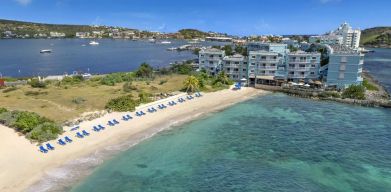 Oyster Bay Resort in St. Martin with buildings along beach and bay. 