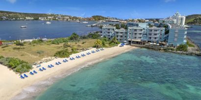 Oyster Bay Resort in St. Martin with buildings along beach and bay. 