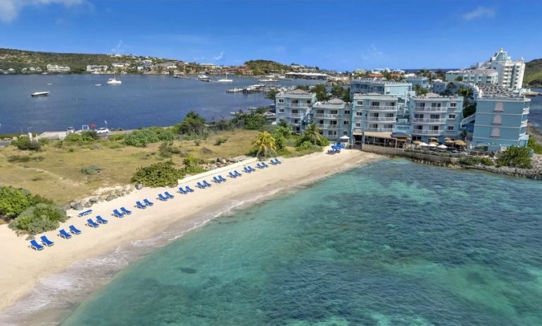 Oyster Bay Resort in St. Martin with buildings along beach and bay. 