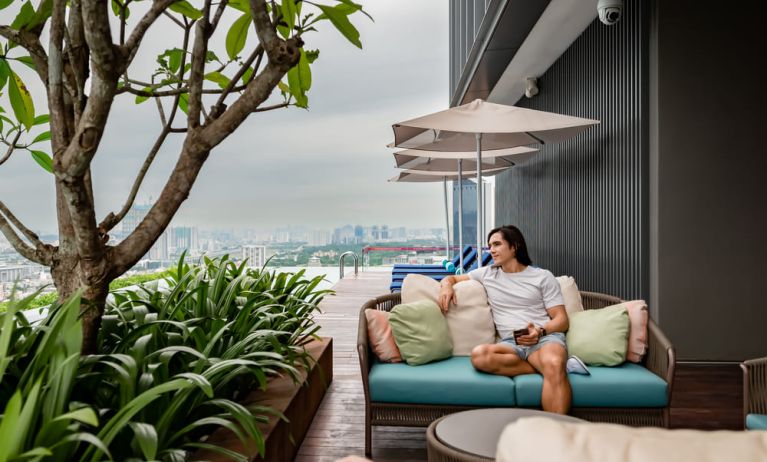 Outdoor pool with pool chairs at Capri By Fraser Bukit Bintang.