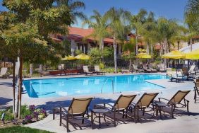 Outdoor pool with pool loungers at DoubleTree By Hilton Ontario Airport.