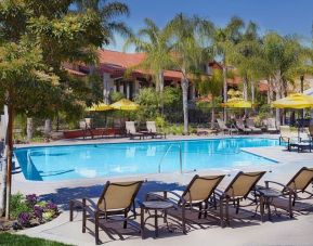 Outdoor pool with pool loungers at DoubleTree By Hilton Ontario Airport.