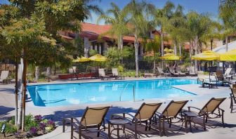 Outdoor pool with pool loungers at DoubleTree By Hilton Ontario Airport.