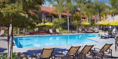 Outdoor pool with pool loungers at DoubleTree By Hilton Ontario Airport.