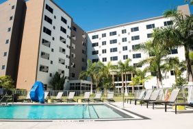 Hotel pool with loungers at Element Miami Doral.