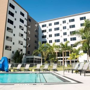 Hotel pool with loungers at Element Miami Doral.