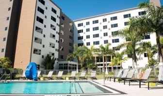 Hotel pool with loungers at Element Miami Doral.