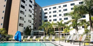 Hotel pool with loungers at Element Miami Doral.