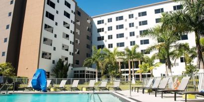 Hotel pool with loungers at Element Miami Doral.