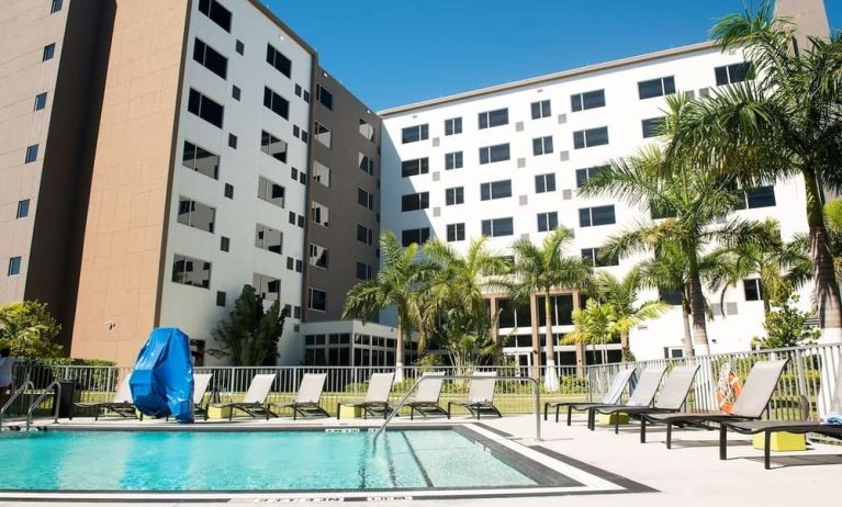 Hotel pool with loungers at Element Miami Doral.