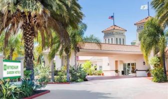 Parking and hotel exterior at Uptown Oasis San Jose Airport.