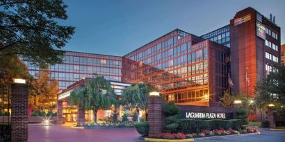 Hotel exterior at night at Laguardia Plaza Hotel.