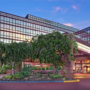 Hotel exterior and parking at Laguardia Plaza Hotel.