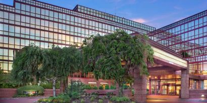 Hotel exterior and parking at Laguardia Plaza Hotel.