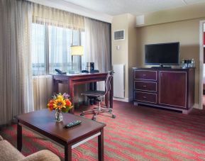 Spacious king room with lounge area at Laguardia Plaza Hotel.