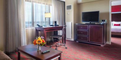 Spacious king room with lounge area at Laguardia Plaza Hotel.