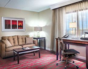 King room with lounge and work desk at Laguardia Plaza Hotel.