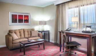 King room with lounge and work desk at Laguardia Plaza Hotel.