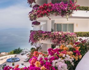 Luxury hotel with flowers at Grand Miramar All Luxury Suites & Residences.