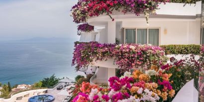 Luxury hotel with flowers at Grand Miramar All Luxury Suites & Residences.