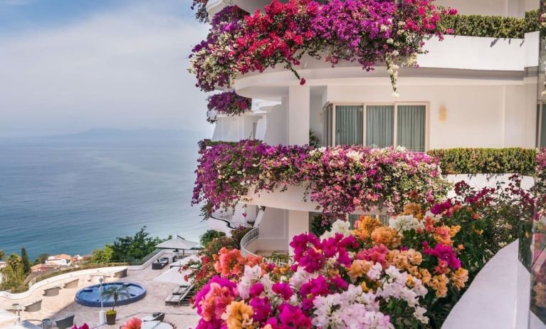 Luxury hotel with flowers at Grand Miramar All Luxury Suites & Residences.