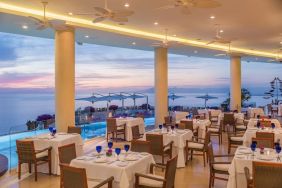 Dining room with sea view at Grand Miramar All Luxury Suites & Residences.