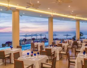 Dining room with sea view at Grand Miramar All Luxury Suites & Residences.