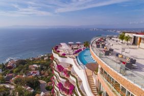 Hotel exterior with pool and ocean view at Grand Miramar All Luxury Suites & Residences.