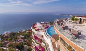 Hotel exterior with pool and ocean view at Grand Miramar All Luxury Suites & Residences.