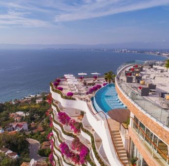 Hotel exterior with pool and ocean view at Grand Miramar All Luxury Suites & Residences.