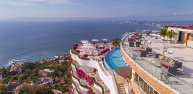 Hotel exterior with pool and ocean view at Grand Miramar All Luxury Suites & Residences.