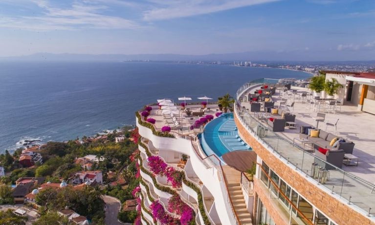 Hotel exterior with pool and ocean view at Grand Miramar All Luxury Suites & Residences.